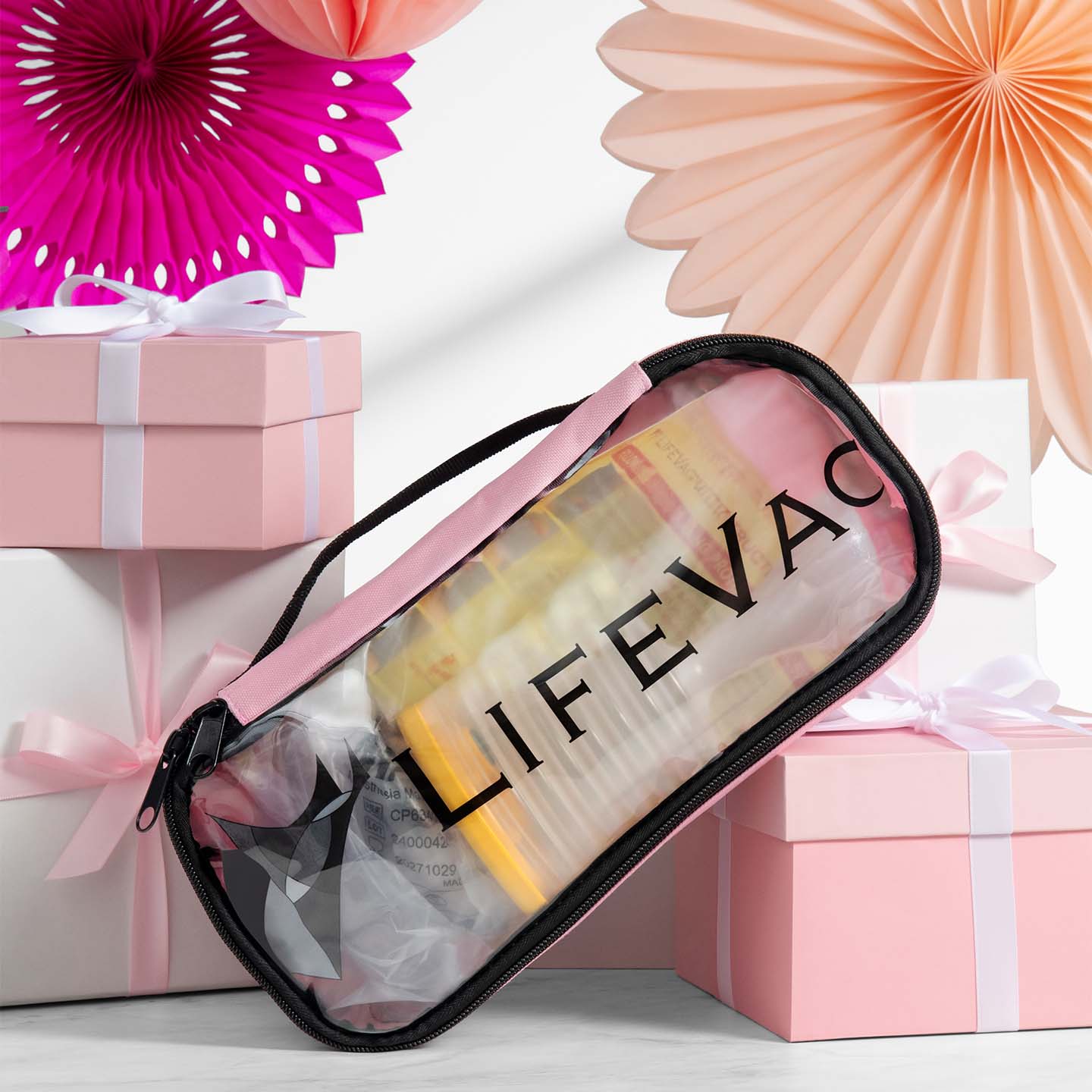 Pink LifeVac Travel Kit set against pink gift boxes and decorative items.